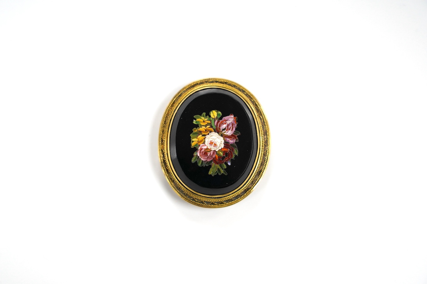 A yellow metal and oval micro-mosaic set pendant, decorated with flowers, 36mm. Condition - fair to good